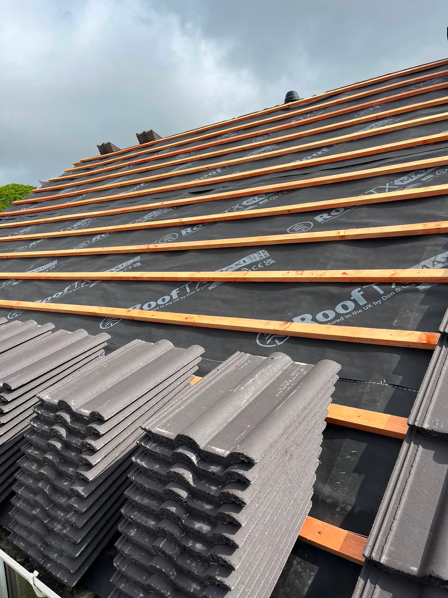 House scaffolded for a re-roof by RML Roofing Services